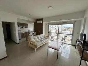 a living room with a couch and a table at Departamento céntrico in Salta +8 photos