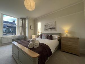 a bedroom with a large bed with towels on it at Ellergill in Keswick