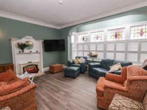 a living room with two couches and a fireplace at South Bay Beach House in Bridlington