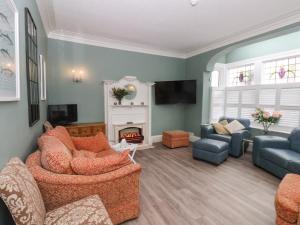 a living room with two couches and a fireplace at South Bay Beach House in Bridlington
