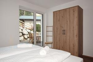 a bedroom with two beds and a sliding glass door at Alpin 1100 in Steeg