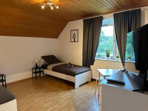 um quarto com uma cama e uma secretária com uma televisão em 3-Zimmer Apartment für Monteure & Geschäftsreisende: Schnelles Internet em Stemshorn