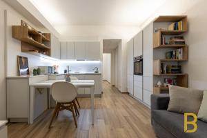 a kitchen and living room with a table and a couch at BePlace Apartments in Gioia in Milan
