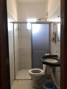 a bathroom with a toilet and a sink at Pousada Villa Aruna in Barra Grande