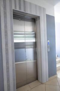 a glass door to a closet in a room at Garden estate thika road in Nairobi