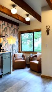 a living room with two chairs and a table at The Bygone in Wimberley