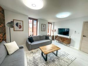 a living room with a couch and a table at Euro Loft Old Town Apartament in Gdańsk