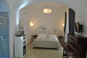 Postel nebo postele na pokoji v ubytování Core Amalfitano City Suites