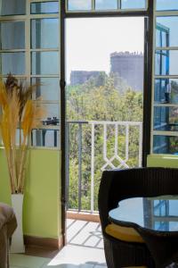 a room with a table and a large window at Garden estate thika road in Nairobi