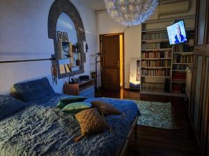 a bedroom with a bed and a chandelier at Locazione Gattapone 1A in Gubbio