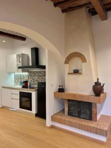 a kitchen with a brick fireplace in a room at La casina nel convento in Asciano