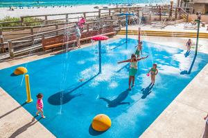 a group of people playing in a swimming pool at the beach at Sundestin Beach Resort in Destin