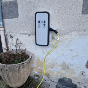 un mando a distancia unido a una pared junto a una planta en Au coeur du Volcantal en Laveissière