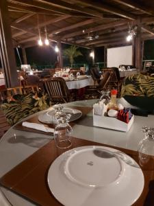 a table in a restaurant with a plate on it at Gran Lençóis Flat Barreirinhas in Barreirinhas