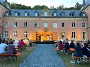 a crowd of people watching a performance on a stage at Chez nathalie in Habay-la-Neuve