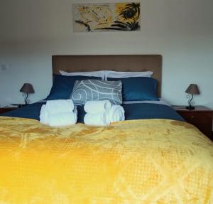 a bedroom with a large bed with towels on it at Casa das Camélias in Viseu