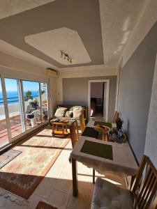 a living room with a table and a view of the ocean at Apartment Ralf in Ulcinj