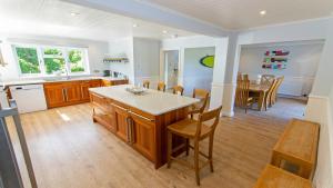 a kitchen and dining room with a table and chairs at Ladywell Croyde - Super stylish large home with pool table, woodburner, pizza oven and Hot Tub Option, Sleeps 12 in Croyde