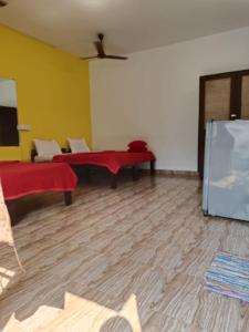 a living room with a table and a refrigerator at Casa De Rocks in Calangute