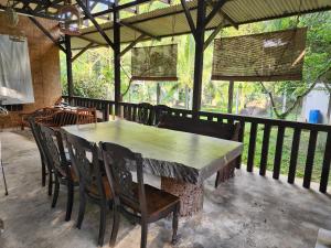 a stone table and chairs on a patio at Rock Forest Chalet in Bentong