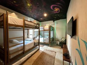 a bedroom with bunk beds and a ceiling with a universe at BULUC LUCH PH para grupos con Roof top y alberca privada in Tulum +31 photos