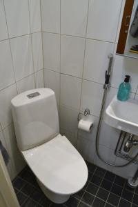 a bathroom with a white toilet and a sink at Modern and Bright Studio with Top Location in Helsinki