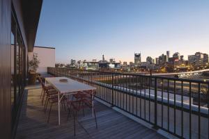 a table and chairs on a balcony with a city skyline at Drift Nashville in Nashville