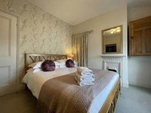 a bedroom with two beds and a mirror on the wall at Spa Cottage in Braithwaite