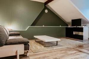 a living room with a couch and a table at Appartement - Octave 29 in Le Havre