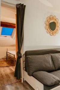 a bedroom with a bed and a mirror on the wall at Appartement - Octave 29 in Le Havre