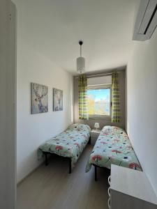 Zimmer mit 2 Betten und einem Fenster in der Unterkunft Finestra sul mare in Monfalcone