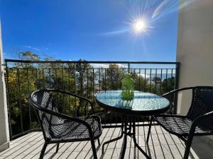 a glass table and chairs on a balcony at Finestra sul mare in Monfalcone