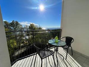 a table and chairs on a balcony with a view at Finestra sul mare in Monfalcone