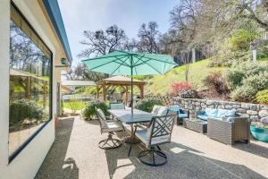 a table and chairs with an umbrella on a patio at Pet-Friendly Jackson Wine Country Home with Pool! in Jackson