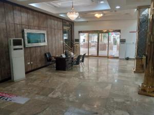 an empty lobby with a desk and chairs at Immaculate Diamond Hotel & Apartments in Abuja
