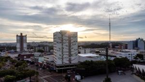 a view of a city with a tall white building at Copas Verdes Hotel in Cascavel
