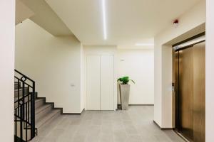 a hallway with stairs and a potted plant at residenza luxury in pieno centro storico in Iseo