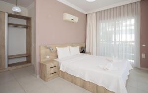 a bedroom with a white bed and a window at Villa Raya3 in Fethiye +23 photos