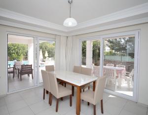 a dining room with a table and chairs at Villa Raya3 in Fethiye