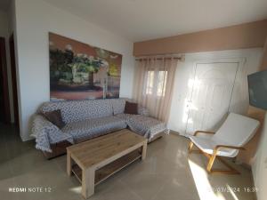 a living room with a couch and a coffee table at Votsalo House in Hora Sfakion