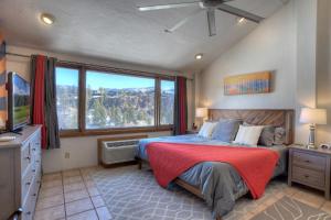a bedroom with a large bed and a large window at Tamarron Lodge Suite 502 in Durango +50 photos