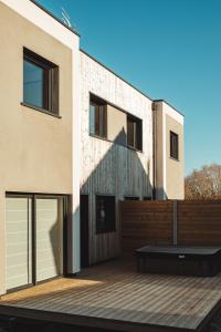 a house with a wooden deck in front of it at ENTRE TERRE ET MER in Desvres