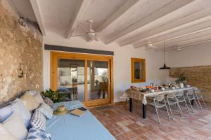 a living room with a couch and a table at Casa Rural Boutique - Ca Bolo in Pinell de Bray