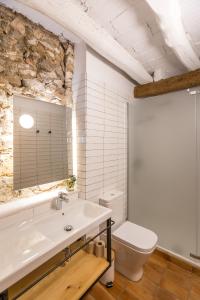 a bathroom with a sink and a toilet at Casa Rural Boutique Ca Bolo in Pinell de Bray