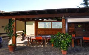 a patio with a table and chairs under a pavilion at Appartamenti Pian d'Alma in Punta Ala