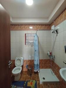 a bathroom with a toilet and a sink at Stella's Apartment in Áyios Pávlos