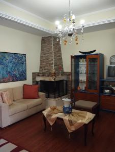 a living room with a couch and a fireplace at Stella's Apartment in Áyios Pávlos