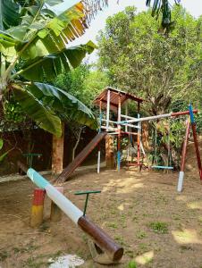 a playground with a swing set and a swing at Pousada Bosque dos Papagaios in Búzios