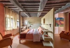 1 dormitorio con cama, escritorio y silla en Monteverdi Tuscany, en Castiglioncello del Trinoro