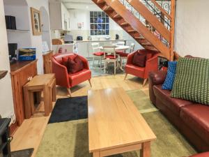 a living room with a couch and chairs and a table at Partridge Holme in Bowness-on-Windermere